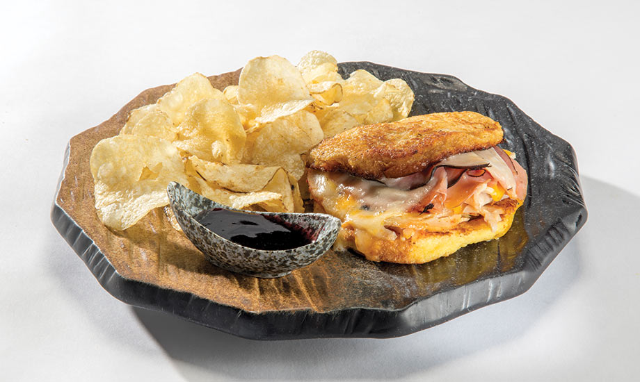 Image shows the Cristo sandwich with potato chips