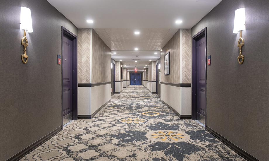 Image of the hotel hallway with doors to the rooms on either side.