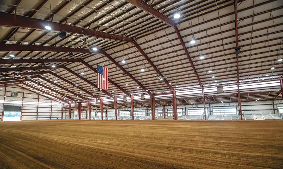 Image shows a corner view of the indoor show ring and bleacher seating in the Equestrian Center