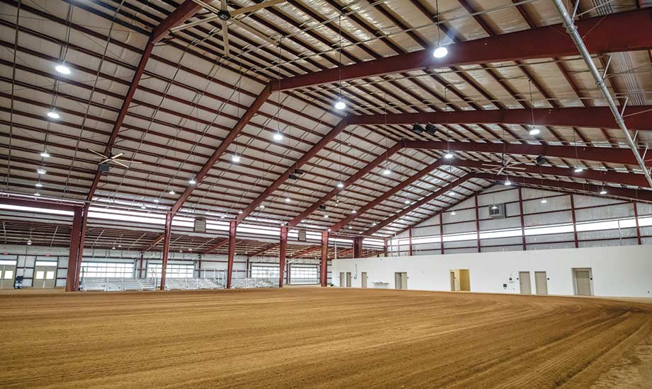 Image shows indoor show ring and seating inside the Equestrian Center
