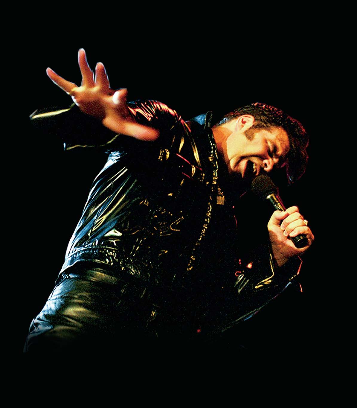image of "Tribute to the King" Elvis impersonator clad in all black leather and singing