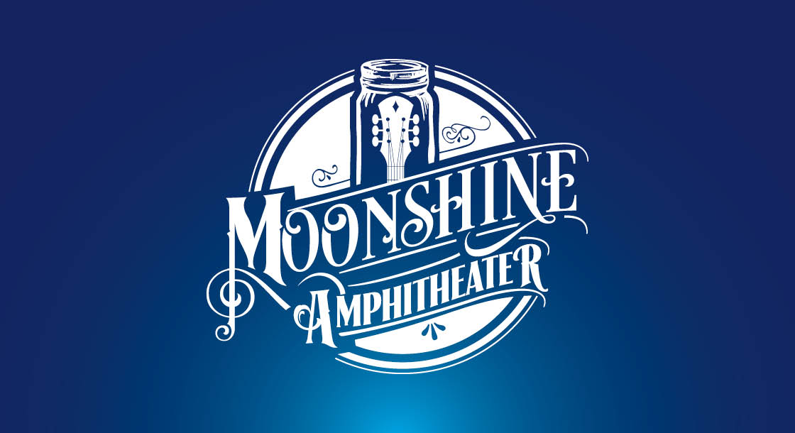 White Moonshine Amphitheater logo in front of a dark blue background.